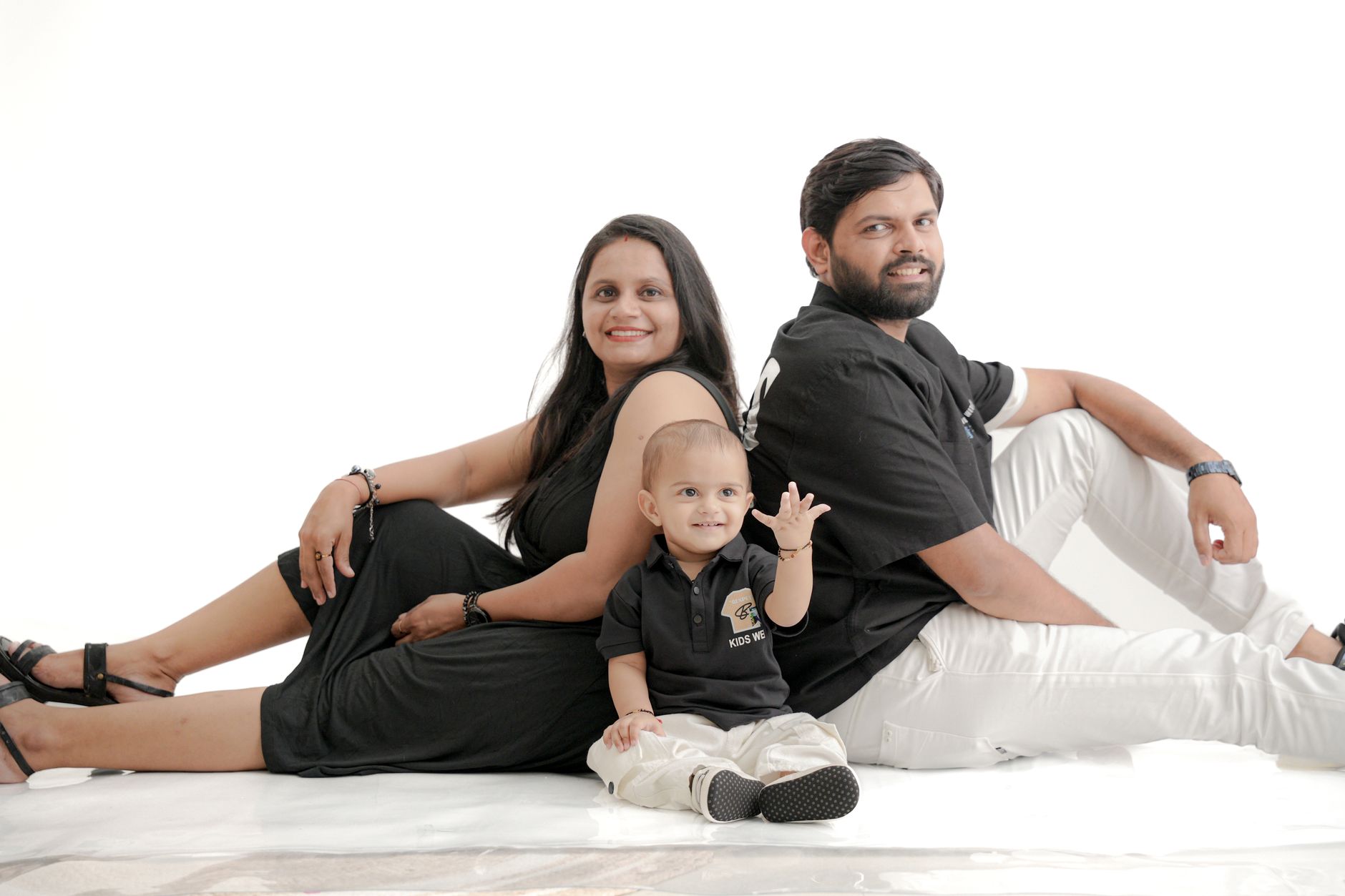 Parents and toddler on a white set